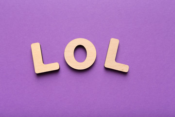 LOL abbreviation spelled with wooden letters