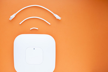 Corporate network concept. Wirelesss(wi-fi) icon. Aceess points (APs) on the orange background. Top view. Space for a text. Close up.