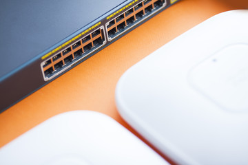 Corporate network concept. Set of ethernet switches, access points, cables, connectors, laptops on...