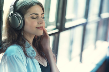 Beautiful girl listening to music on headphones