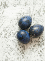Quail eggs in the nest on stone background.
