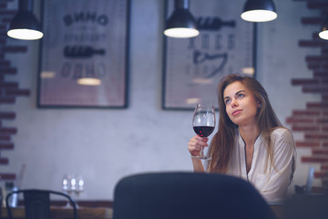 Young attractive girl with a glass of wine