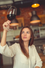 Young sommelier with a glass of red wine