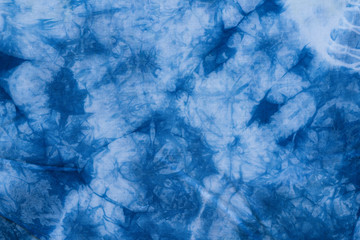 Pattern of blue tie batik dye on cotton cloth, Dyed indigo fabric background and textured - obrazy, fototapety, plakaty