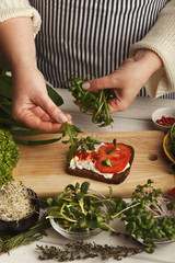 Woman making tasty bruschettas for healthy snack, closeup