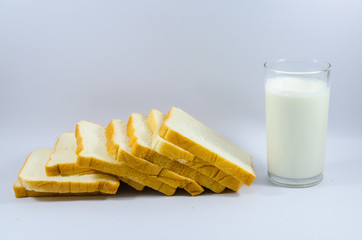 milk and Bread lined on a white background.