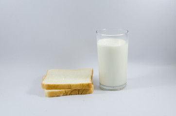 milk and Bread lined on a white background.