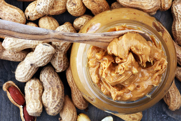 Creamy peanut butter on wood table. Selective focus.