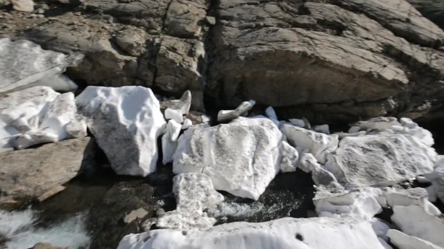 Mountain river, glacier. Firn snow. Spring in mountain