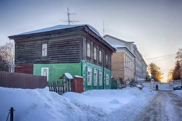 Old houses in ancient Russian city of Kolomna, Moscow region, Russia, after snowfall. Winter overcast day.