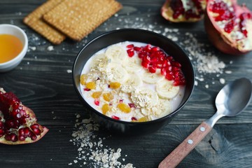 Diet yoghurt smoothie bowls with fruit slices, oatmeal and pomegranate. Delicious healthy food, meal for breakfast, low calorie snack for weight losing and well-being