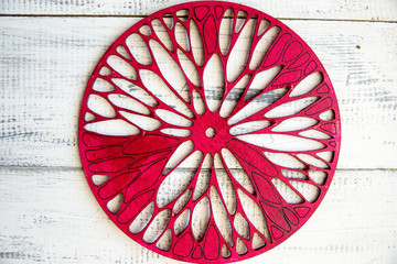 red carved circles with ornament on wooden background