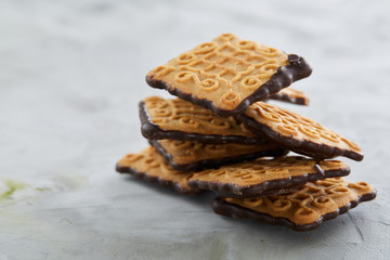 Square biscuits arranged in pattern on light textured background, close-up, shallow depth of field, selective focus.