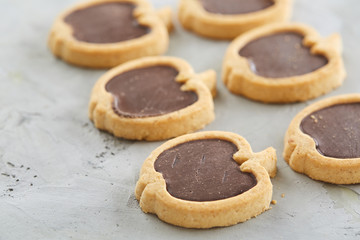 Apple shaped biscuits arranged in rows on light textured background, close-up, shallow depth of field, selective focus.