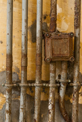 Old electricity on yellow wall