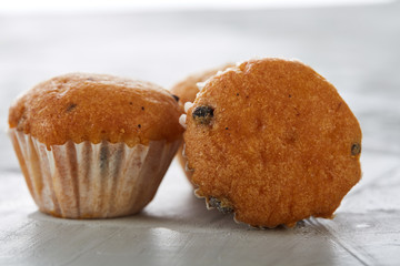 Tasty muffins arranged in pattern on light textured background, close-up, shallow depth of field, selective focus.