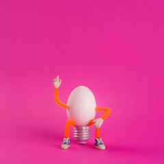 Easter egg toy in the shape of a light bulb on a pink