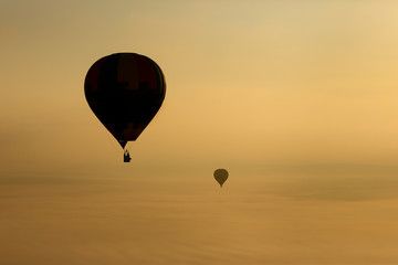 Naklejka premium Hot air balloons, atmosphere ballons flying over mountain landscape at Mallorca in the sunrise