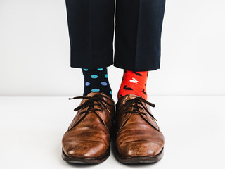 Office Manager in stylish shoes, blue pants and bright, colorful socks on a white background....
