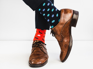 Office Manager in stylish shoes, blue pants and bright, colorful socks on a white background....