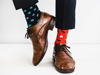 Office Manager in stylish shoes, blue pants and bright, colorful socks on a white background. Lifestyle, fashion, fun
