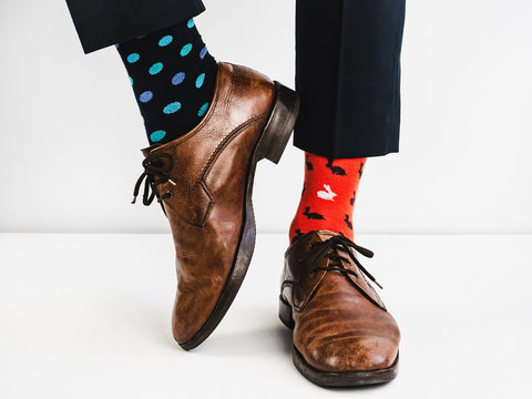 Office Manager In Stylish Shoes, Blue Pants And Bright, Colorful Socks On A White Background. Lifestyle, Fashion, Fun