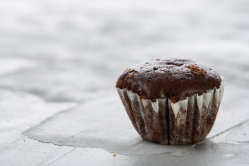 Tasty muffins arranged in pattern on light textured background, close-up, shallow depth of field, selective focus.