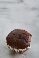 Tasty muffins arranged in pattern on light textured background, close-up, shallow depth of field, selective focus.