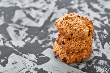 Sweet cookies arranged in pattern on light textured background, close-up, shallow depth of field, selective focus.