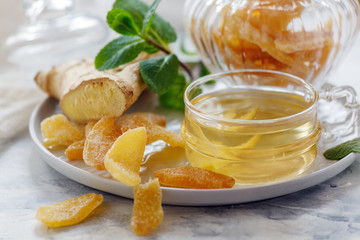 Ginger tea and slices of candied ginger closeup.