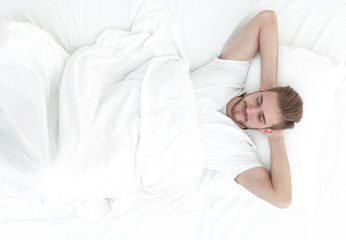 top view.young man relaxing on the sofa