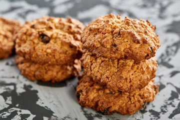 Sweet cookies arranged in pattern on light textured background, close-up, shallow depth of field, selective focus.
