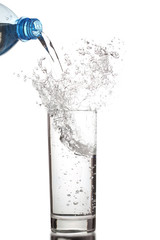 Pouring water into glass isolated on white