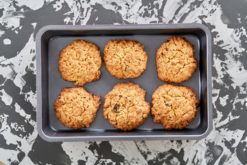 Fresh baked biscuits on a cookie sheet, top view, close-up, selective focus, shallow depth of field.