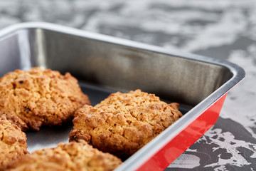 Fresh baked biscuits on a cookie sheet, top view, close-up, selective focus, shallow depth of field.