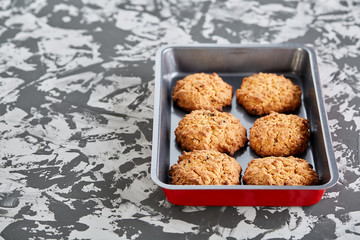Fresh baked biscuits on a cookie sheet, top view, close-up, selective focus, shallow depth of field.