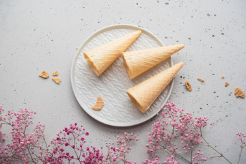 wafers on a gray background, decoration with pink flowers