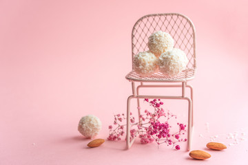 coconut cookies on a pink background, decoration with pink flowers