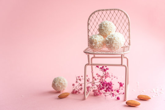 coconut cookies on a pink background, decoration with pink flowers
