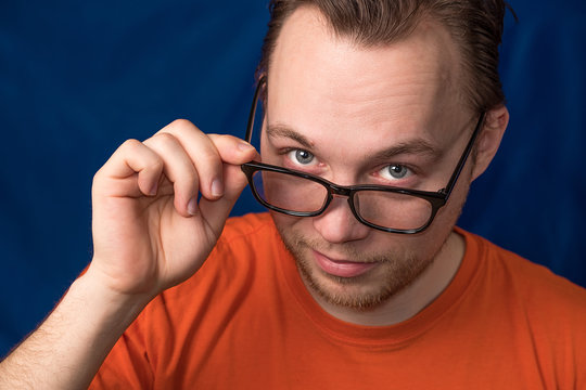 portrait of a man who looks over his glasses