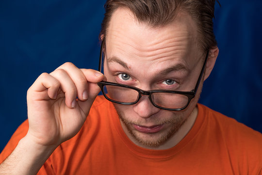 portrait of a man who looks over his glasses