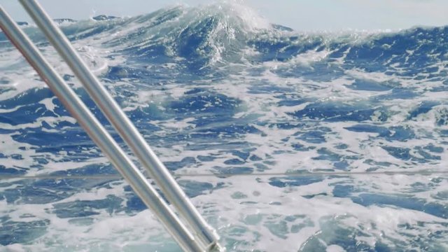 Slow motion view of ocean water over board of yacht