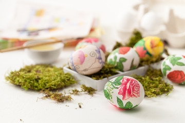 Decoupage on white eggs. The decoration of eggs for Easter.