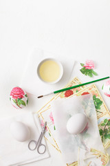 Decoupage on white eggs. The decoration of eggs for Easter.