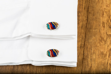 Cufflinks with shirt on the wooden ground