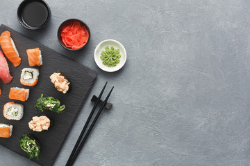 Set of sushi maki and rolls on grey background © Prostock-studio
