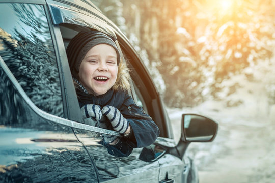 Happiness Caucasian Smilling Boy Looking Out Of Black Car Window