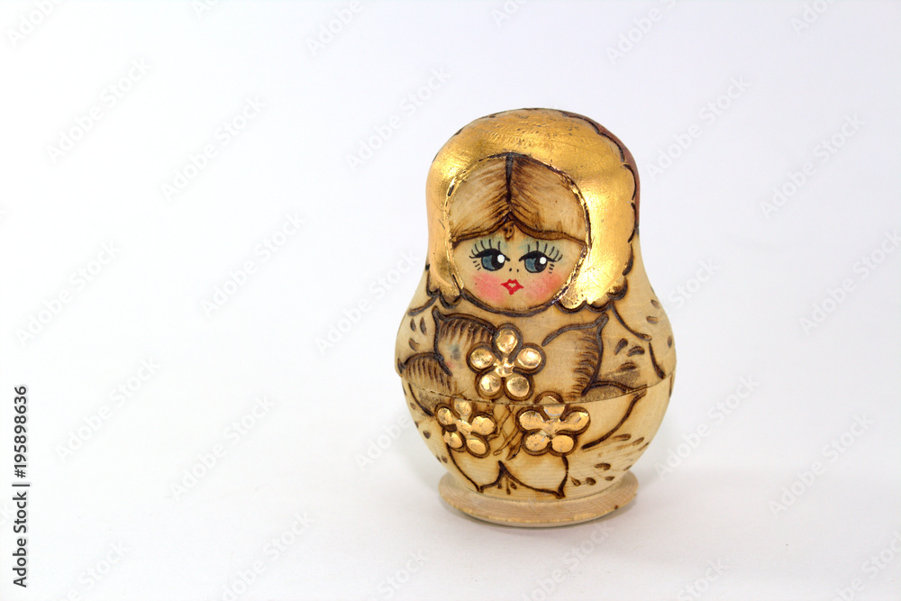 Wall mural Russian folk toy - wooden matryoshka doll on white background close-up