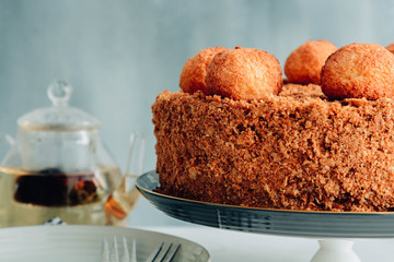 Round multi-layered cake Napoleon with custard and tea.