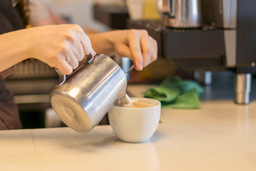 Fototapeta na wymiar Barista prepares cappuccino. Sunny morning. Coffee machine in cafe